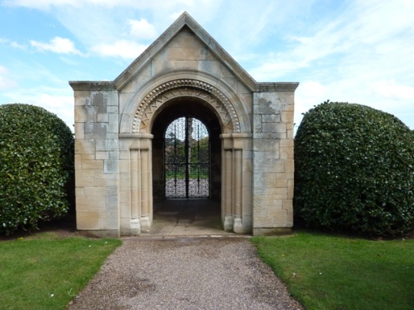 The intricate wrought iron gate framed by the archway, Church, Holbeck, Sherwood Forest